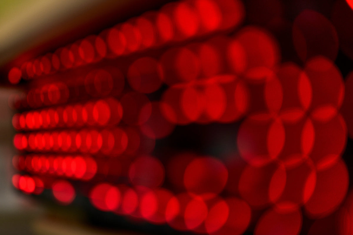Red LED bokeh macro of a red light therapy panel, out of focus